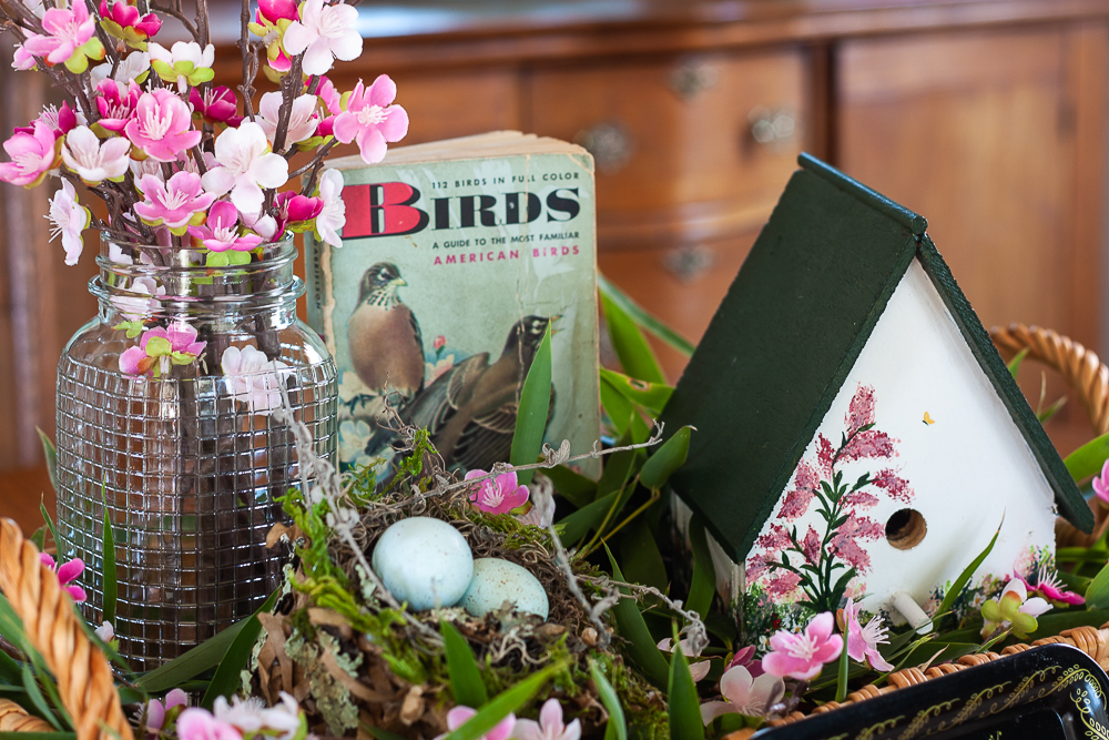 Handmade bird house with a 1949 Birds Golden Nature Guide and pink flowers in a clear, embossed Mason Jar